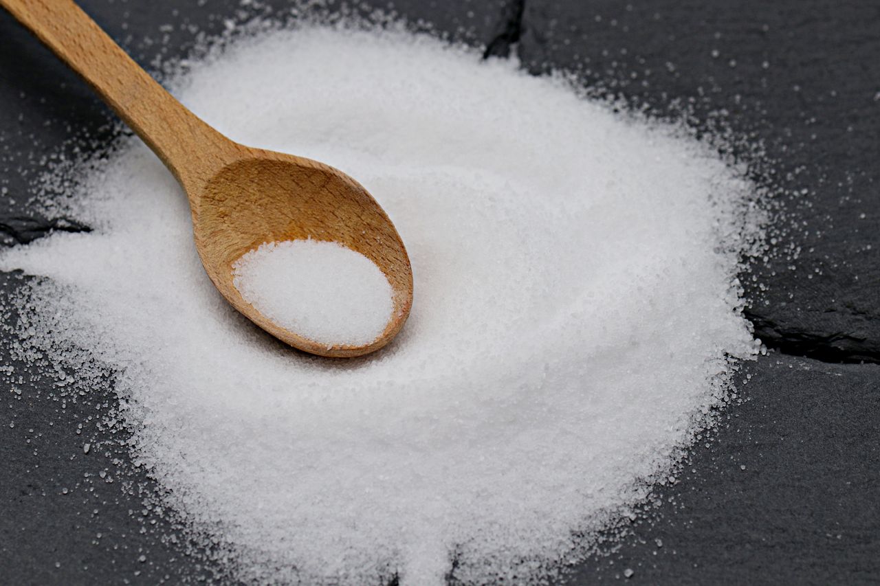 The Art of Drawing Readers In: Your attractive post title goes here Close-up of a wooden spoon with sea salt on a slate background, perfect for culinary themes.